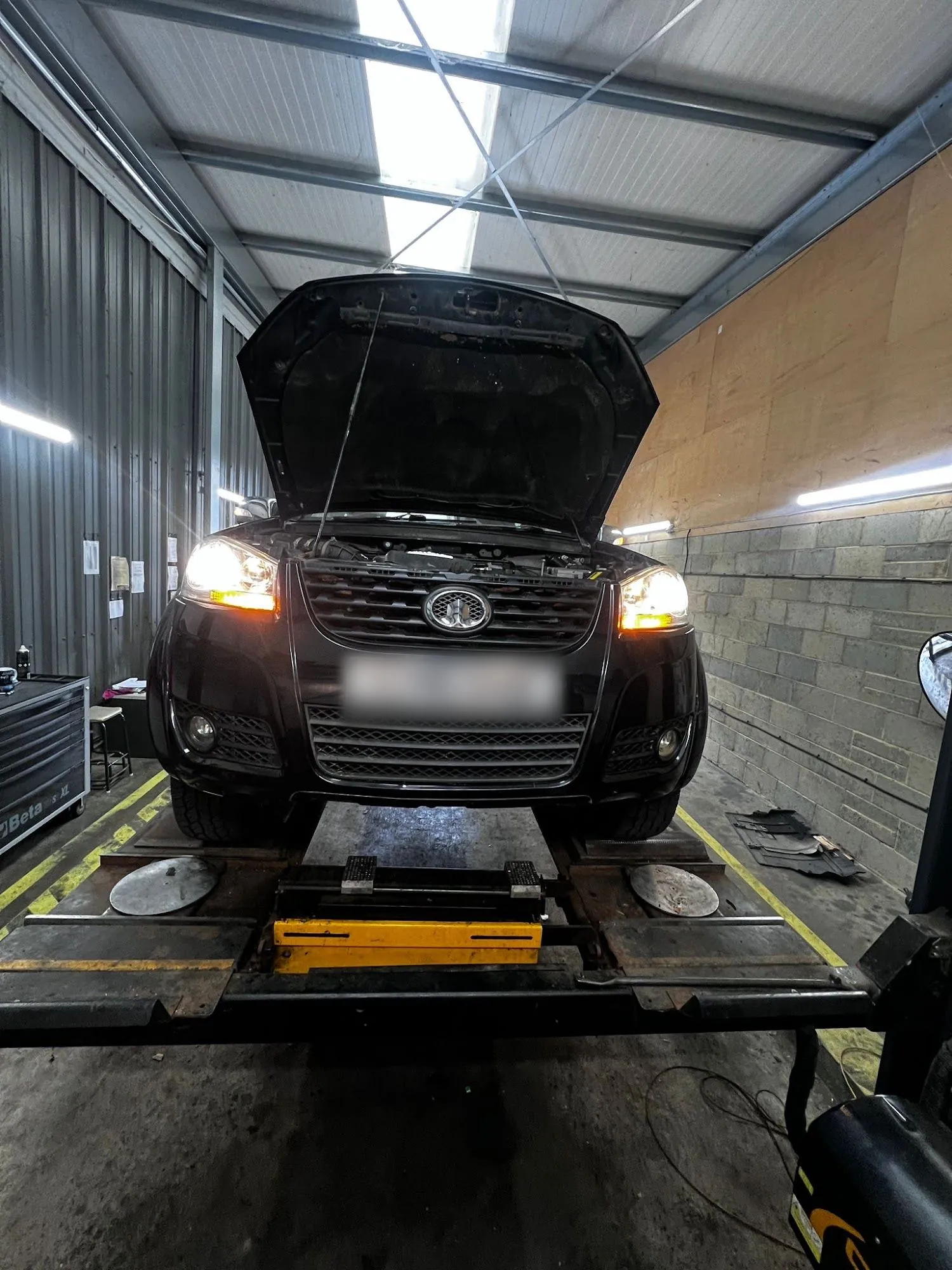 Car up on the ramp in the JRock Autos workshop